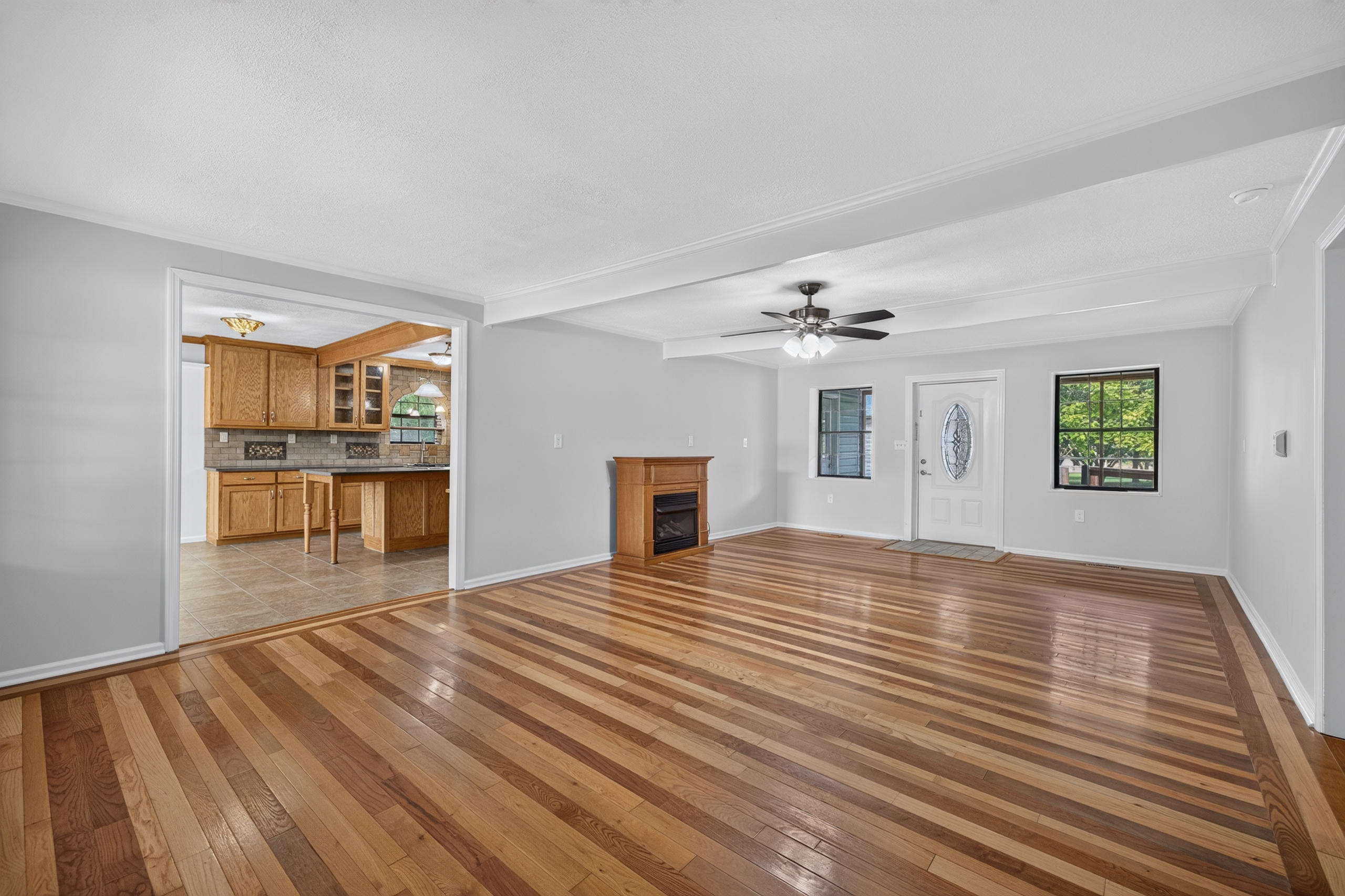 Living room with fireplace and beamed ceiling
